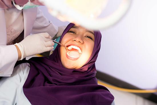 Girl at the dentist getting a checkup